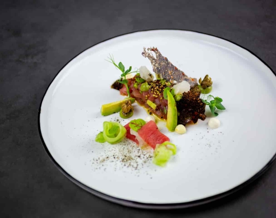 Stilvoll und edel angerichtetes Fischgericht mit Avocado und Kräutern bei einem Event-Catering in Stuttgart von Markus Grein.